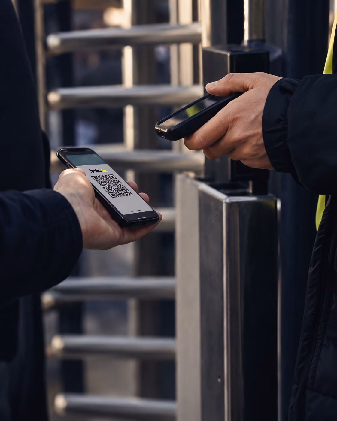 A steward scanning the QR code on a fan's Fantastix ticket at a turnstile
